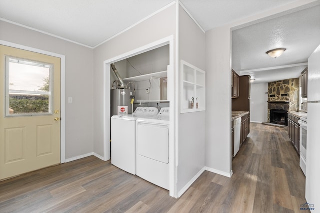 102 E Madison, Rapid City, SD 57001 - laundry room with separate washer and dryer, dark wood-style flooring, a fireplace, electric water heater, and ornamental molding