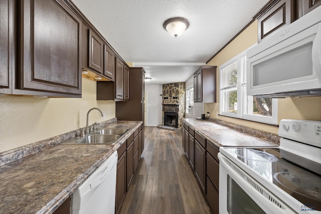 102 E Madison, Rapid City, SD 57001 - kitchen with white appliances, dark brown cabinetry, dark wood-style flooring, a fireplace, and a textured ceiling