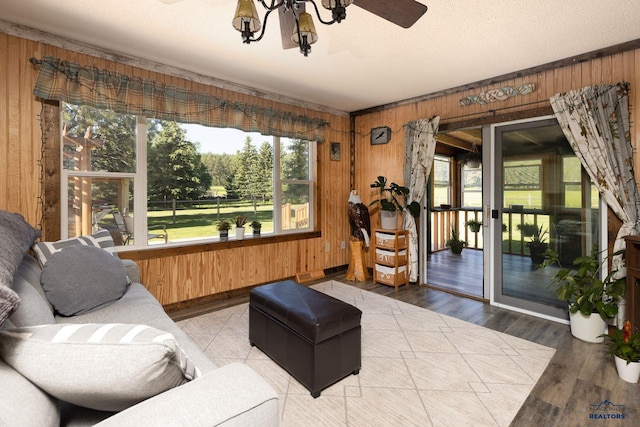 13000 Deer Creek Ln, Rapid City, SD 57702 - living room with wood walls, wood finished floors, and a chandelier