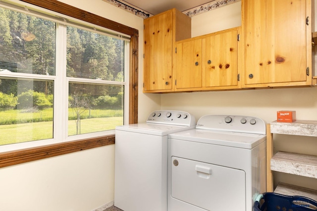 13000 Deer Creek Ln, Rapid City, SD 57702 - laundry area with cabinet space and washing machine and clothes dryer