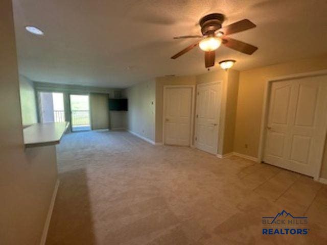 3600 Sheridan Lake Rd Unit # 222, Rapid City, SD 57702 - unfurnished living room featuring ceiling fan and light carpet