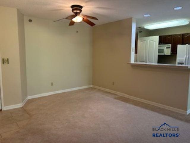 3600 Sheridan Lake Rd Unit # 222, Rapid City, SD 57702 - unfurnished living room featuring a ceiling fan, recessed lighting, and light carpet