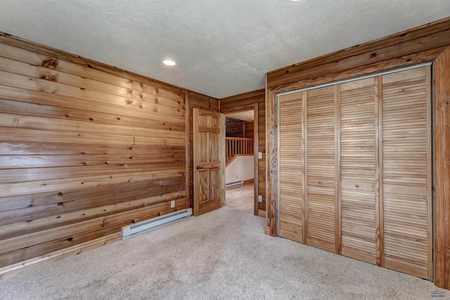 23217 Carbon Loop, Rapid City, SD 57702 - unfurnished bedroom with baseboard heating, carpet floors, a textured ceiling, recessed lighting, and a closet