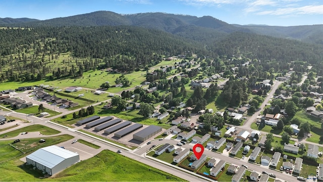 3053 Trailhead Loop, Sturgis, SD 57785 - aerial view of residential area featuring a heavily wooded area and a mountainous background