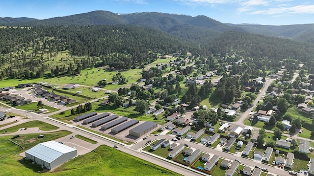 3053 Trailhead Loop, Sturgis, SD 57785 - aerial overview of property's location with a mountain backdrop and nearby suburban area