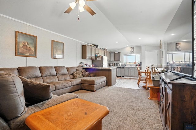 3053 Trailhead Loop, Sturgis, SD 57785 - living area featuring vaulted ceiling, a ceiling fan, light wood-style floors, and light carpet