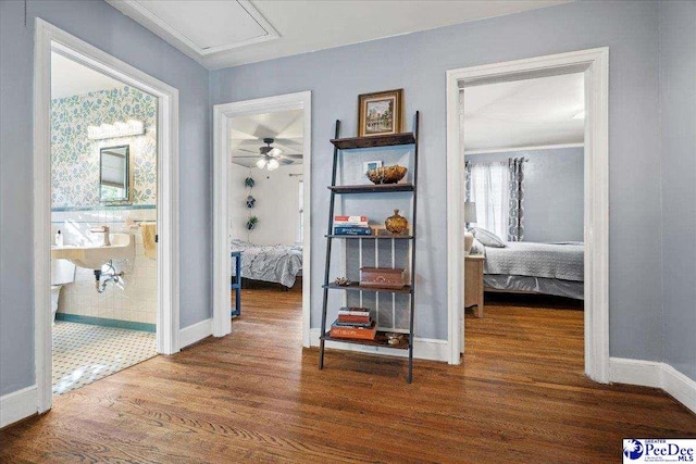 hallway featuring baseboards and wood finished floors