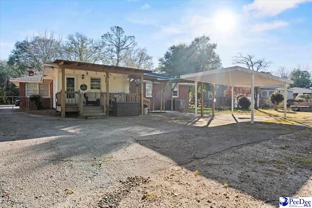 view of front of property featuring a carport and aphalt driveway