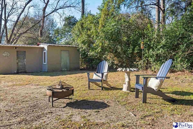 view of yard with a fire pit