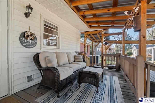 wooden terrace featuring an outdoor living space