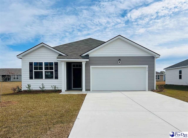 ranch-style house with a garage and a front lawn