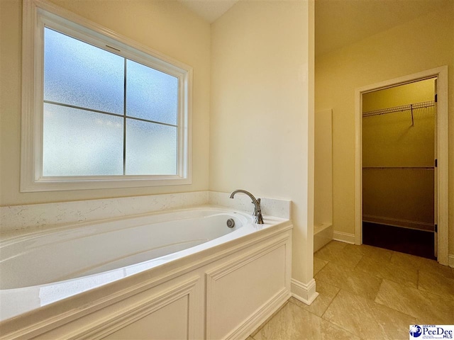 bathroom with a tub to relax in