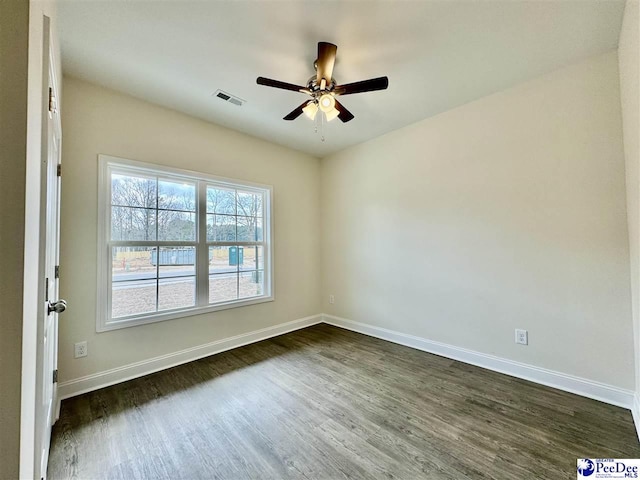 unfurnished room with dark wood-type flooring and ceiling fan