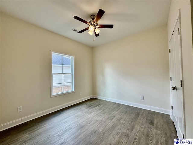 spare room featuring ceiling fan and dark hardwood / wood-style flooring