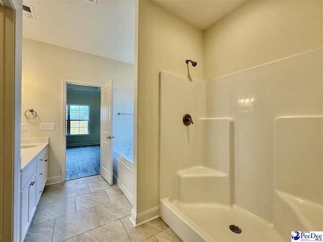 bathroom featuring tile patterned floors, vanity, and separate shower and tub