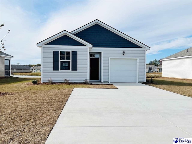 view of front of property featuring a garage and a front lawn