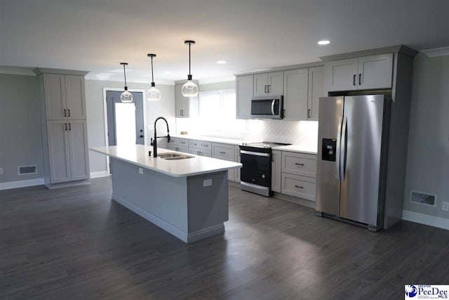 kitchen featuring gray cabinets, decorative light fixtures, sink, a kitchen island with sink, and stainless steel appliances