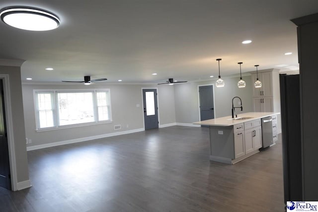 kitchen featuring sink, white cabinetry, hanging light fixtures, an island with sink, and stainless steel dishwasher