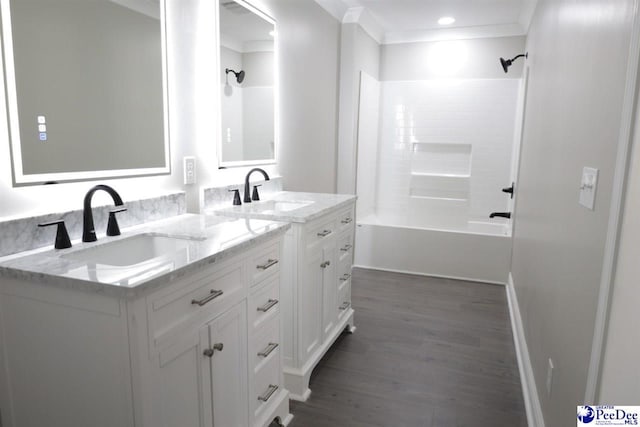 bathroom with vanity, hardwood / wood-style floors, ornamental molding, and tub / shower combination