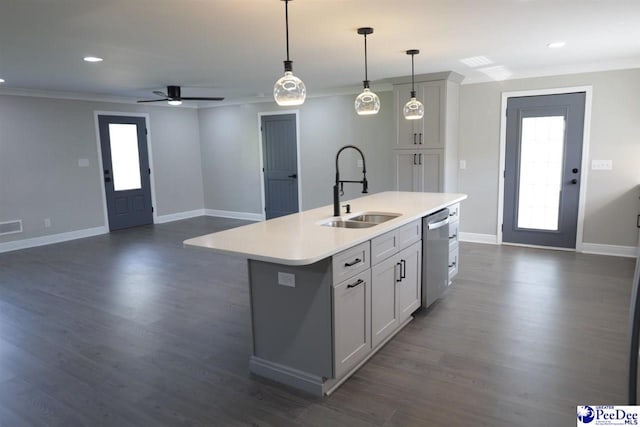 kitchen featuring sink, hanging light fixtures, a center island with sink, stainless steel dishwasher, and a wealth of natural light