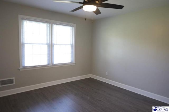 empty room with dark hardwood / wood-style floors and ceiling fan