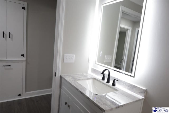 bathroom featuring vanity and hardwood / wood-style floors