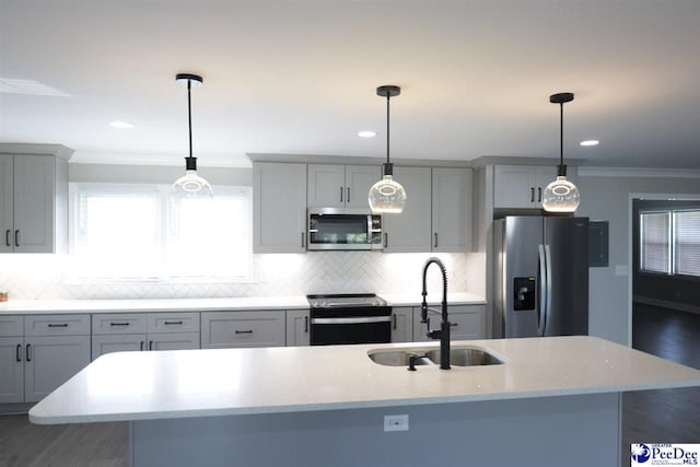 kitchen with sink, hanging light fixtures, and appliances with stainless steel finishes