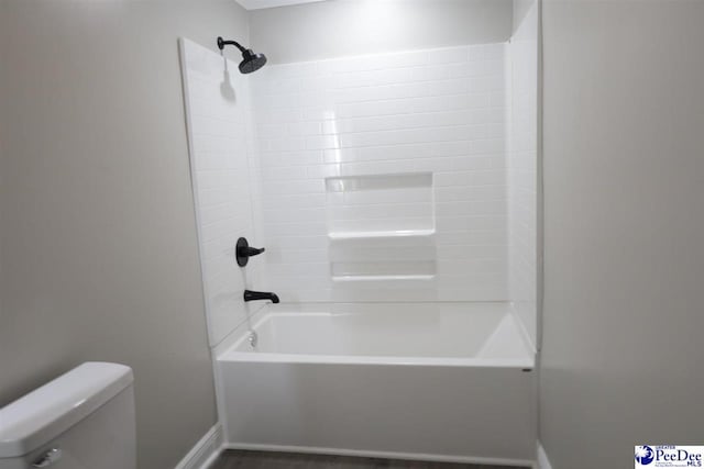 bathroom featuring shower / bathing tub combination and toilet