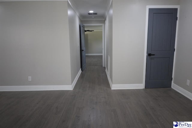 corridor featuring crown molding and dark hardwood / wood-style floors