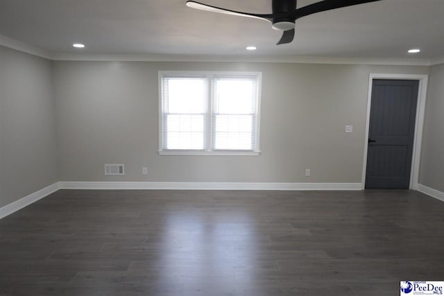 empty room featuring dark hardwood / wood-style flooring, crown molding, and ceiling fan