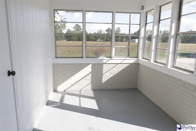 unfurnished sunroom featuring a wealth of natural light