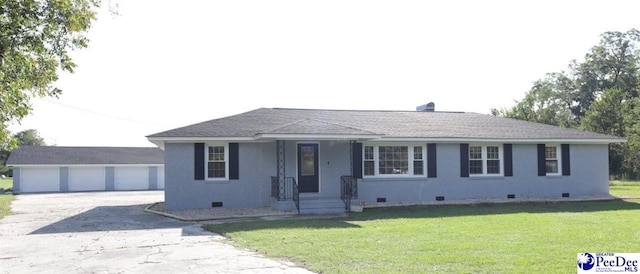 ranch-style home featuring a garage and a front lawn