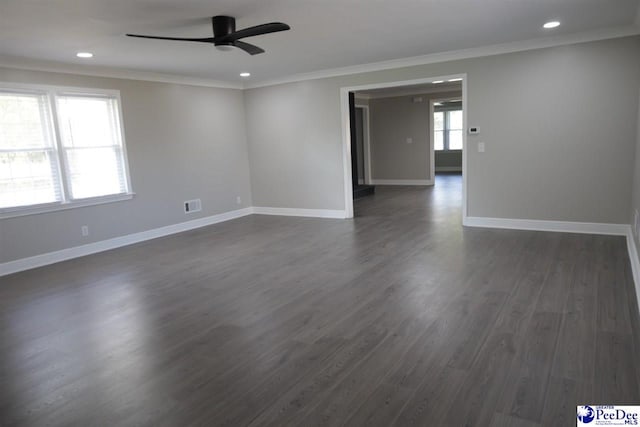 spare room with crown molding, dark hardwood / wood-style floors, and ceiling fan