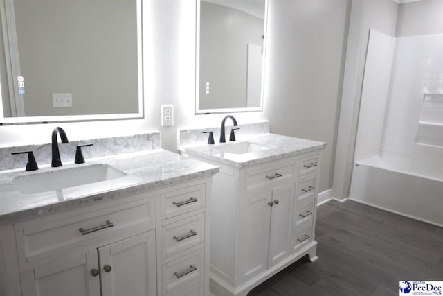 bathroom featuring vanity, shower / washtub combination, and wood-type flooring