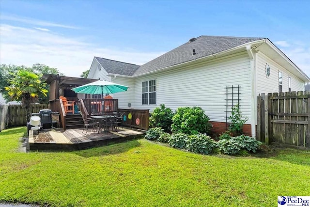 3109 Stillwater Ln, Florence, SC 29501 - back of property featuring a wooden deck, a shingled roof, and outdoor dining area