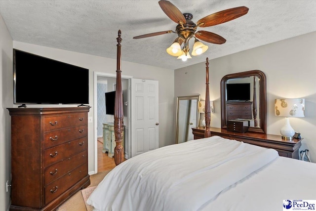 3109 Stillwater Ln, Florence, SC 29501 - bedroom with a textured ceiling, a ceiling fan, light carpet, and ensuite bathroom