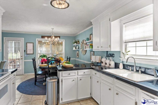 3109 Stillwater Ln, Florence, SC 29501 - kitchen with a sink, a peninsula, white cabinetry, a chandelier, and dark countertops