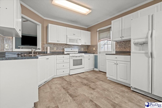 316 Magna Carta Rd, Florence, SC 29501 - kitchen with dark countertops, white appliances, white cabinetry, and crown molding