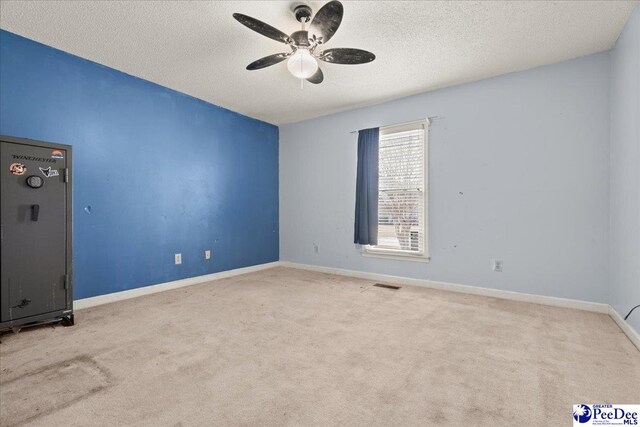 316 Magna Carta Rd, Florence, SC 29501 - carpeted spare room featuring visible vents, baseboards, a textured ceiling, and a ceiling fan
