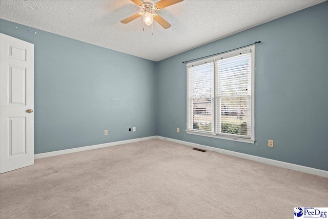 316 Magna Carta Rd, Florence, SC 29501 - empty room featuring a textured ceiling, carpet flooring, baseboards, and ceiling fan