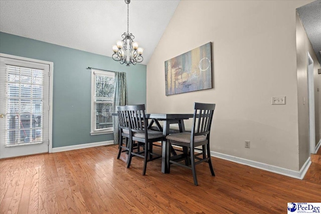 316 Magna Carta Rd, Florence, SC 29501 - dining space featuring an inviting chandelier, baseboards, wood-type flooring, and vaulted ceiling