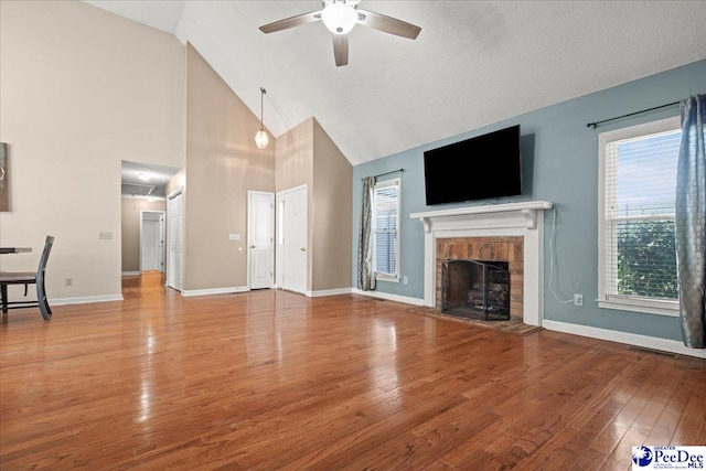 316 Magna Carta Rd, Florence, SC 29501 - unfurnished living room featuring a fireplace with raised hearth, baseboards, a ceiling fan, and hardwood / wood-style flooring