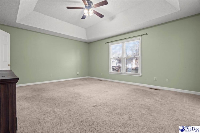 316 Magna Carta Rd, Florence, SC 29501 - spare room featuring visible vents, a raised ceiling, baseboards, and ceiling fan