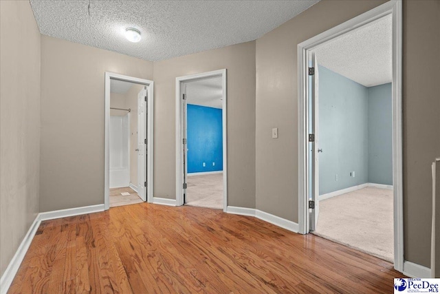 316 Magna Carta Rd, Florence, SC 29501 - unfurnished bedroom featuring wood finished floors, baseboards, and a textured ceiling