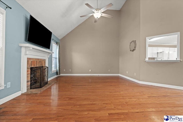 316 Magna Carta Rd, Florence, SC 29501 - unfurnished living room with baseboards, wood finished floors, a brick fireplace, and ceiling fan