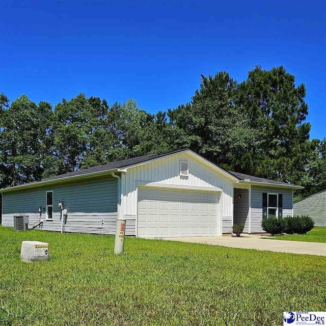 822 Twin Oaks Cir, Lake City, SC 29560 - view of front of property featuring a front yard, board and batten siding, central air condition unit, and an attached garage