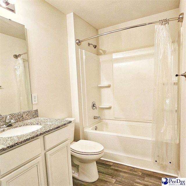 822 Twin Oaks Cir, Lake City, SC 29560 - full bathroom with wood finished floors, shower / bath combo with shower curtain, toilet, and vanity