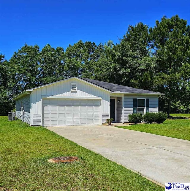 822 Twin Oaks Cir, Lake City, SC 29560 - view of front of house with a front yard, board and batten siding, central air condition unit, an attached garage, and concrete driveway