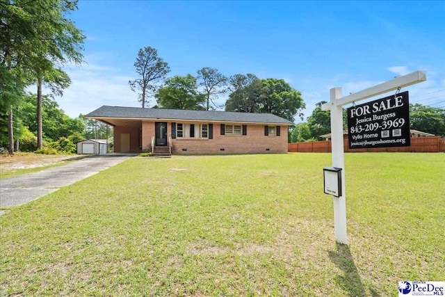 410 N Salem Dr, Florence, SC 29506 - single story home with crawl space, concrete driveway, a front lawn, a carport, and an outbuilding