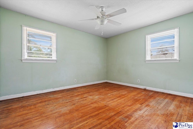 410 N Salem Dr, Florence, SC 29506 - spare room with wood finished floors, a textured ceiling, a ceiling fan, and baseboards